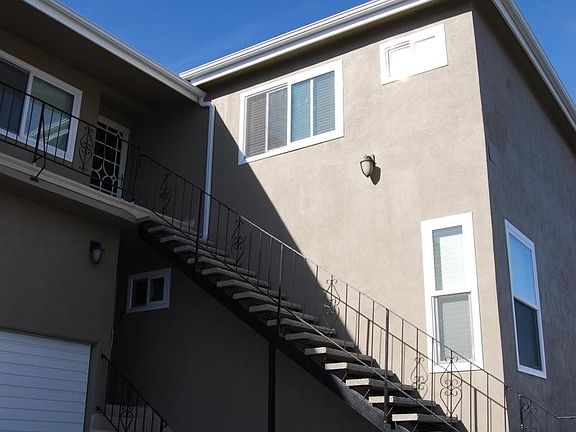 BOTTOM UNIT - Several steps into the unit with garage beside