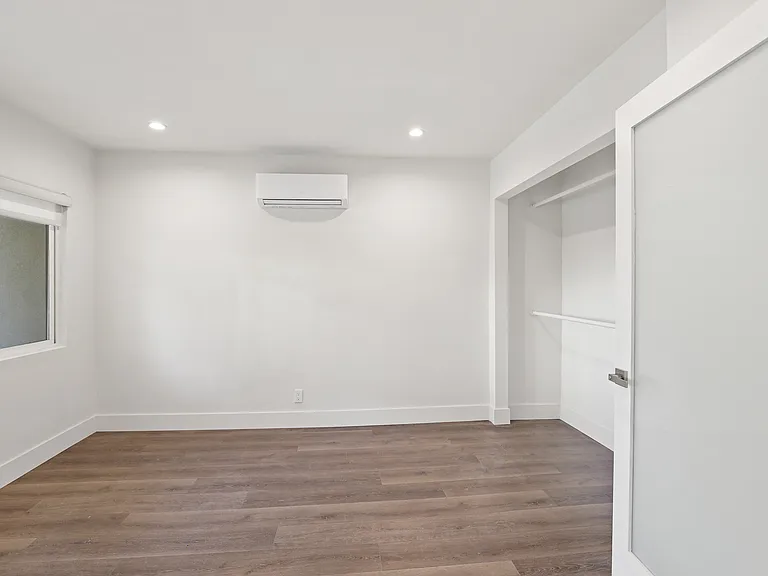 Bedroom with Wall Heater and Closet