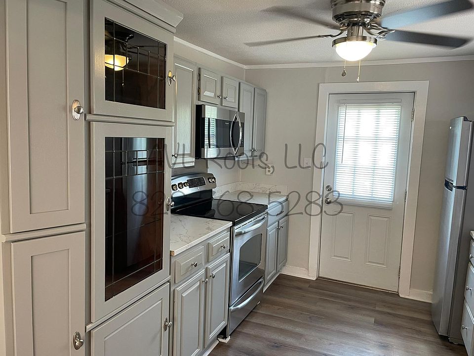 brand new kitchen with plenty of cabinets.