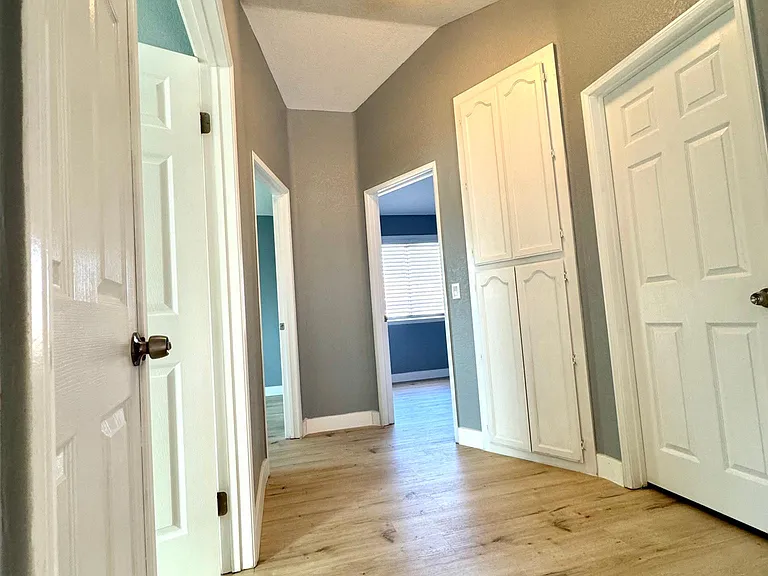 Upstairs open hallway area with linen closet