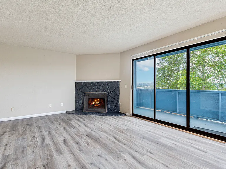 Big deck out of sliding door off the spacious living room with wood burning fireplace