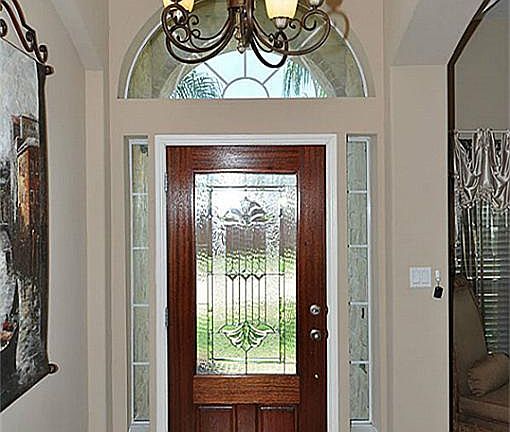 Beautiful foyer with tile entry and bronze fixtures