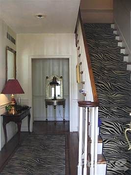 Foyer with Hardwood Floors and Crystal Chandeliers