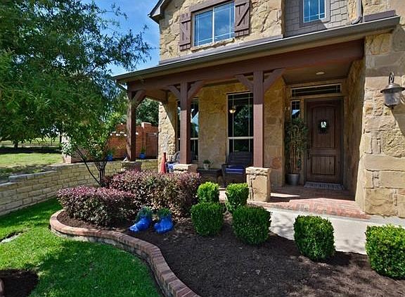 Wonderful large brick covered front porch. There is a large common area next to the front yard which