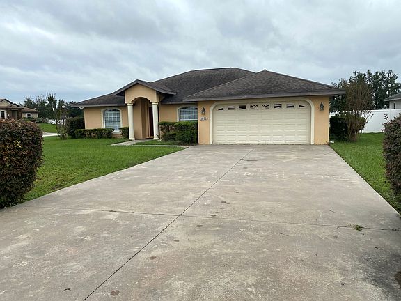 House front view, spacious parking.