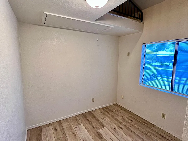 Bedroom 1 with window and pull down ladder access to loft