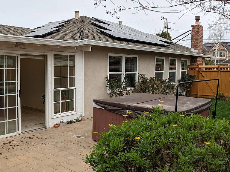 View of yard with lawn, patio, spa.