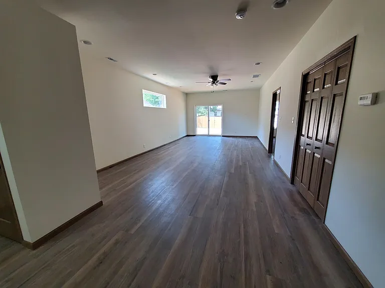 Living Room With Sliding Door To Concrete Patio
