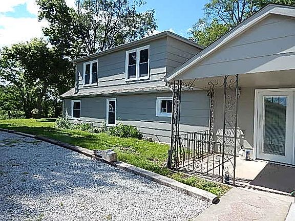 Side drive and double french doors open to the family room.