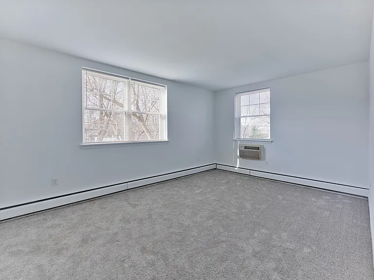 Spacious, light-filled bedroom with plush carpeting at Crestwood Apartments in Wayne, PA