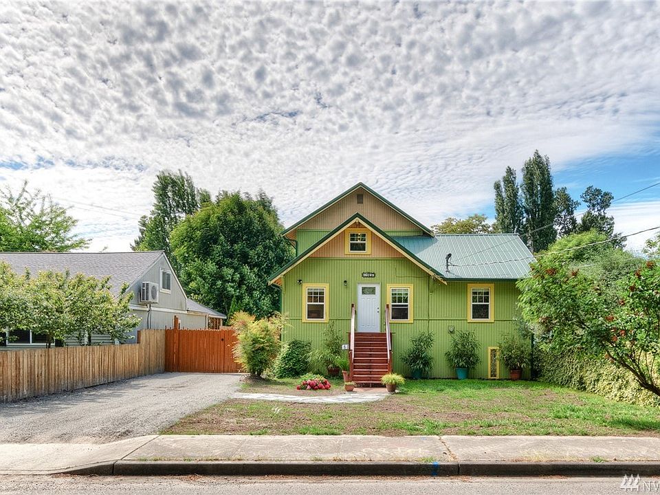 Rebuilt in 2018 this home is like new! Metal roof, new sewer hookup (2020) and a very exceptional, huge, shop behind those locking driveway gates on the left.  Parking for 8+, RV etc.