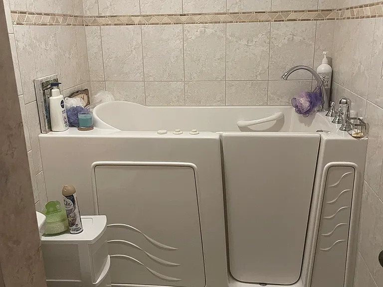 Main bathroom with walk-in tub with hand held shower and jets.