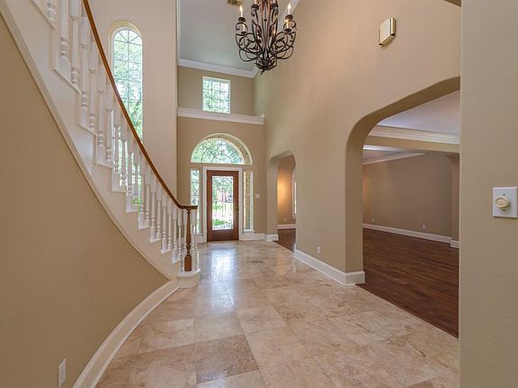 Travertine floors welcome you into this pristine home.