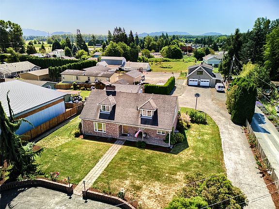 Arial view of the property looking south. Shows home with large shop with unfished ADU & stable and detached garage with studio.>