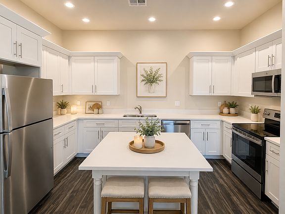2nd Floor: Kitchen with stainless appliances, quartz counters and white shaker cabinets.