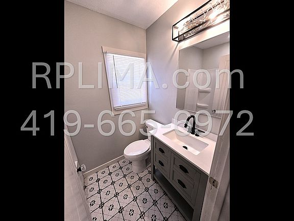Completely updated bathroom with matte black fixtures and elegant crystal-accented lighting