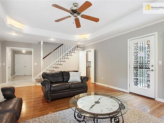Additional view of the Family Room which shows one of 2 exterior doors to the backyard.  This room is located in the back of the house and you can easily see the staircase that leads to the en suite 4th bedroom from this angle as well.