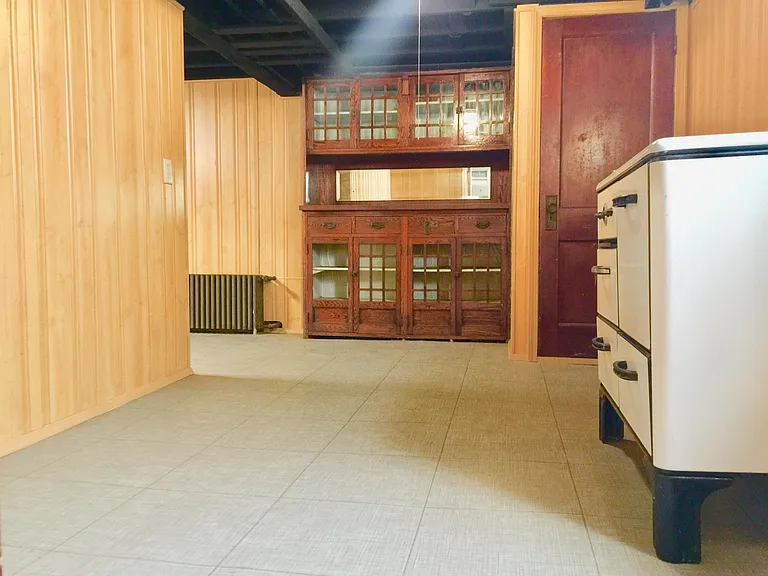 Built-in vintage hardwood bookcase in the second room in the basement
