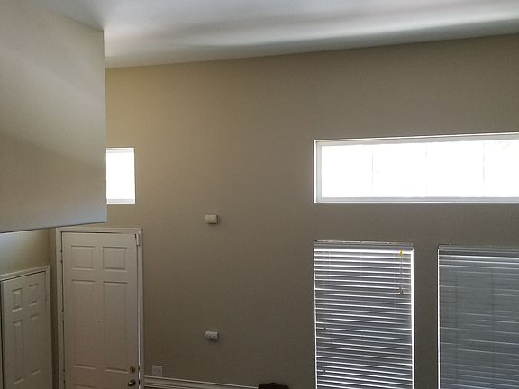 Two-story view on living room entrance & garage door
