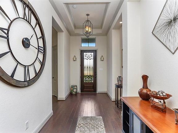 This view shows the open entryway and beautiful front door with privacy glass.