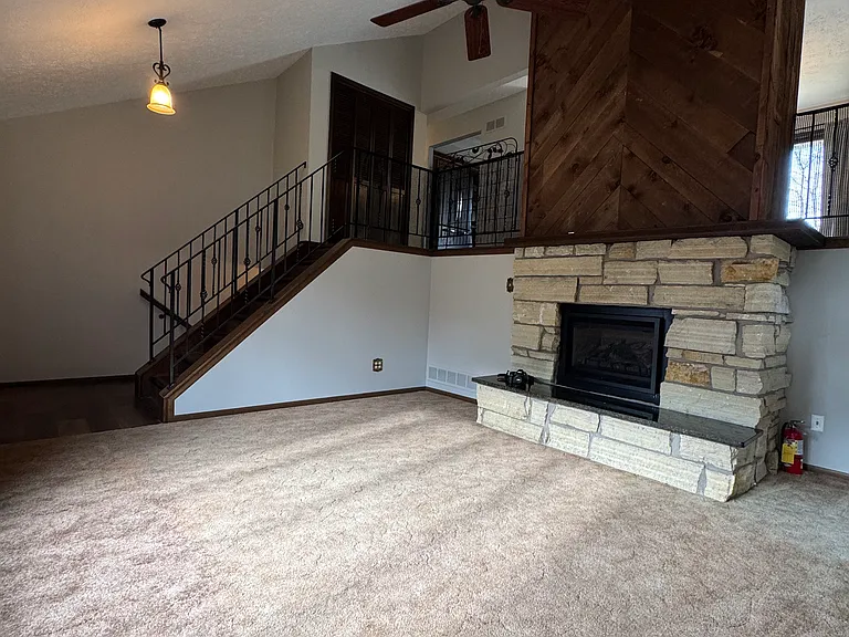 Living room looking at staircase to kitchen, bedrooms, bathrooms and dining room.