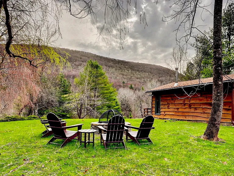 Adirondack chairs surrounding the fire pit in the early spring.