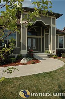 Newly landscaped front entrance with vaulted ceilings