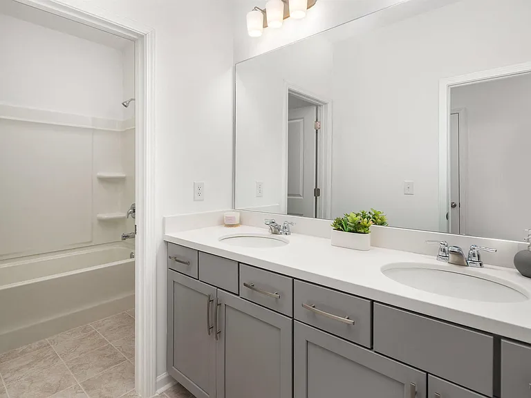 Secondary suite bathroom with a tub and shower combination