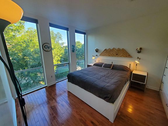 Primary bedroom with floor to ceiling windows.