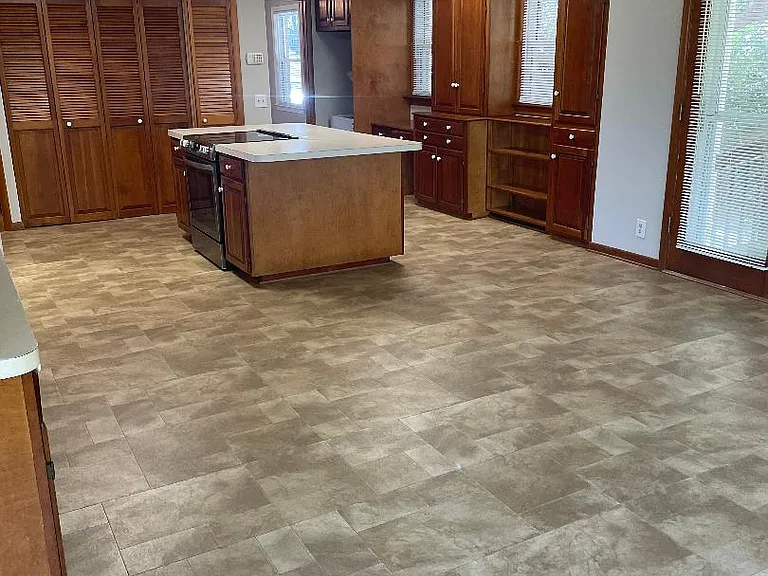 View of the kitchen area with lots of storage cabinets.