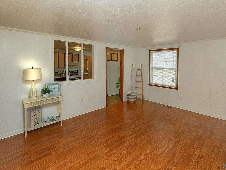 Another living room view showing into the kitchen.