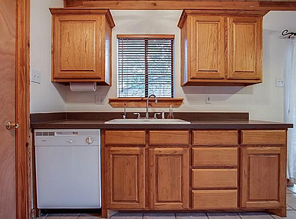 Very clean kitchen with double sink and laundry room