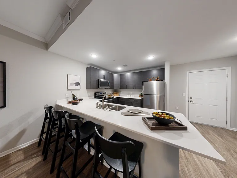 The Dogwood floor plan kitchen includes a breakfast bar perfect for dining, and modern stainless steel appliances. The Dogwood floor plan kitchen includes a breakfast bar perfect for dining, and modern stainless steel appliances.