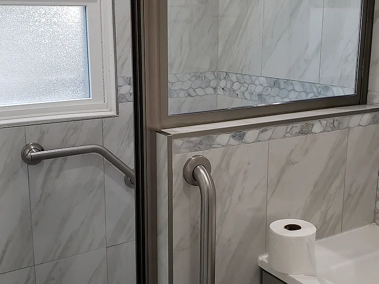 Shower stall with grab bars.