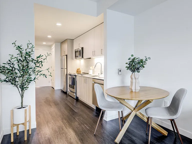 Wood-style plank flooring throughout kitchen, bathrooms and living space.