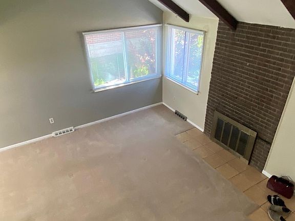 15x16 Family room with vaulted ceiling and woodburning fireplace.