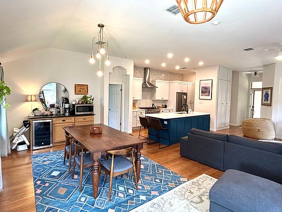 Plenty of lighting with a large and spacious Living, Kitchen with Dining area; including built in Coffee Bar double sided cabinets in the island, wine fridge and peaceful views all around the home.