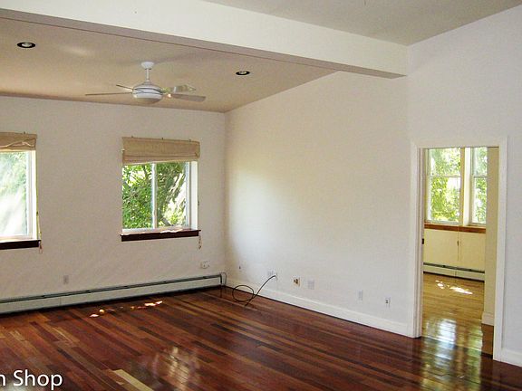 High ceilings, white walls & hardwood floors. Flooded in lig