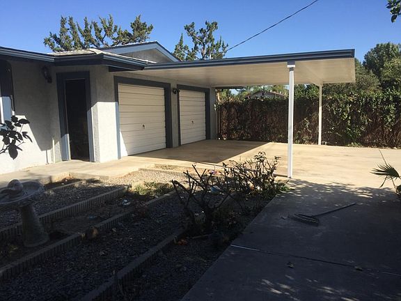 Carport in front of 2 car garage