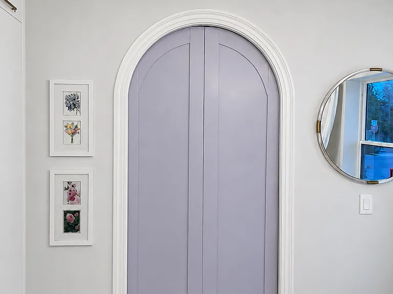 Lavender, custom arched doors (on the bedroom side, white on the living room side : ) add a whimsical architectural focal point,