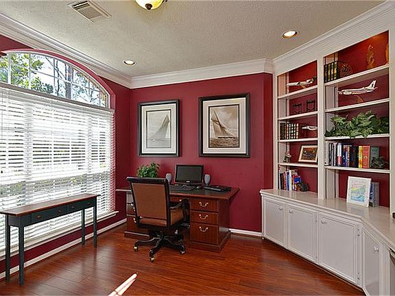 The study features crown molding and wonderful built in book cases.