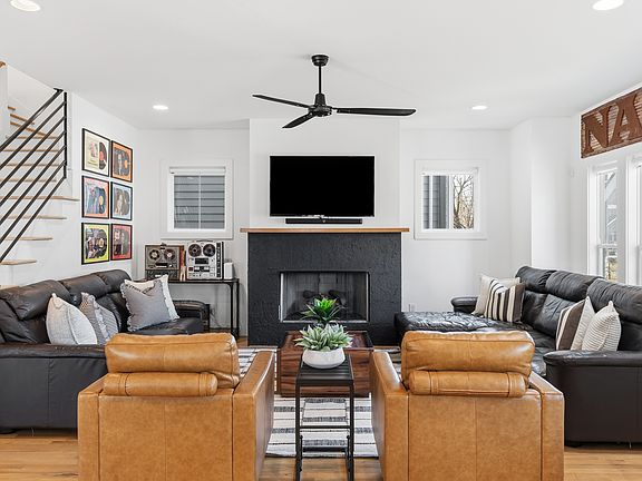 Modern, cozy living room with a gas fireplace, sleeper sofa and a Smart TV with all the streaming apps.