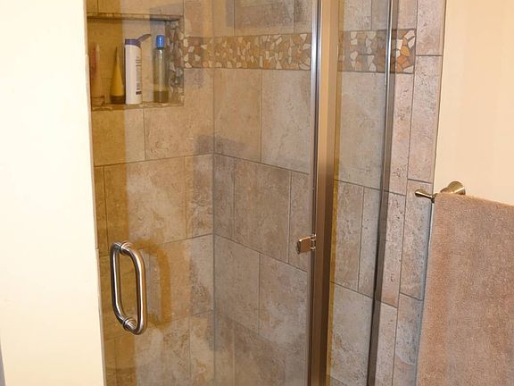 Master bathroom - beautiful tiled shower with glass door