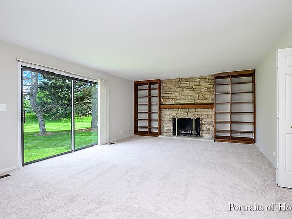 Warm & welcoming family room. Stone fireplace with gas logs flanked by built in bookcases.