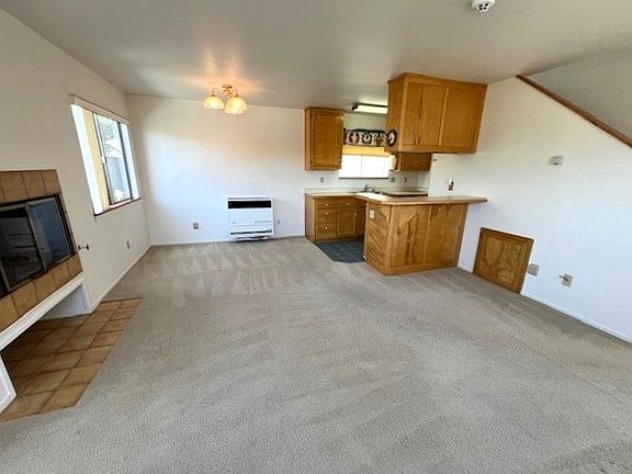 Gas log fireplace, kitchen and dining area