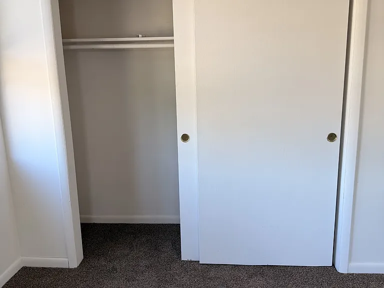 both bedrooms have large closets with lots of rooms for hanging clothes with a shelf above the pole for extra storage