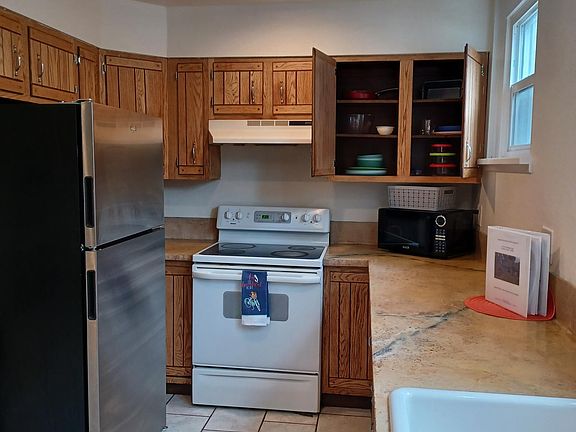 kitchen has 2 full-size fridges