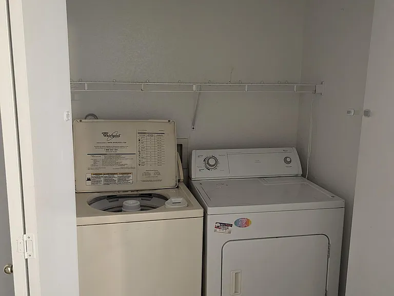 Laundry area in the hall behind folding doors--across the hall from two of the three bedrooms