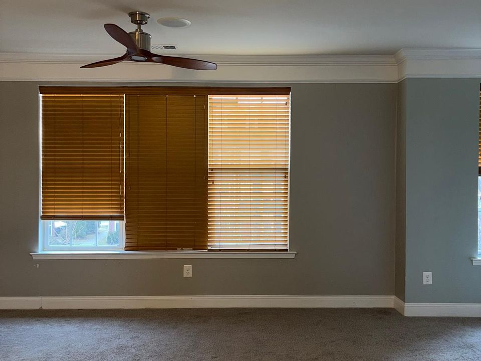 Formal living area with wooden blinds