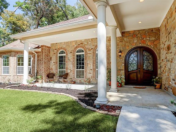 Spacious front porch with custom double doors.